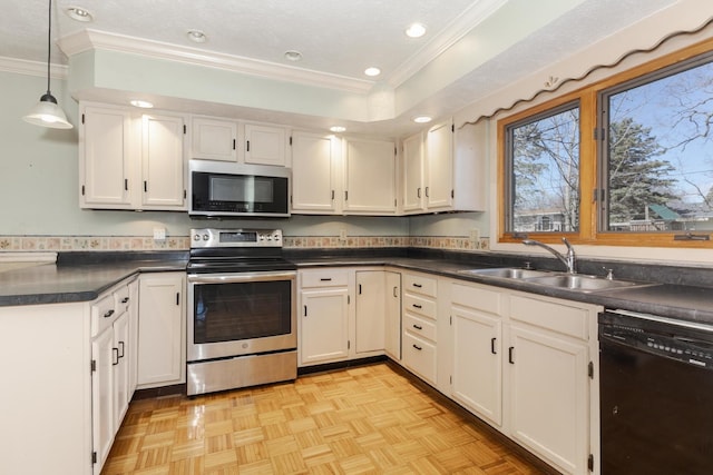 kitchen with a sink, dark countertops, crown molding, and appliances with stainless steel finishes