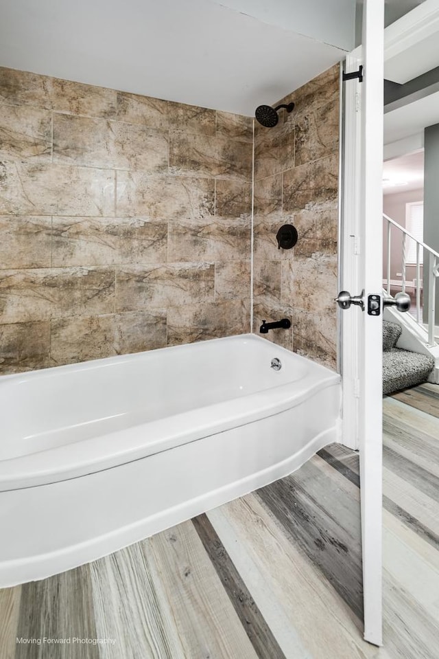 bathroom featuring hardwood / wood-style floors and tiled shower / bath combo