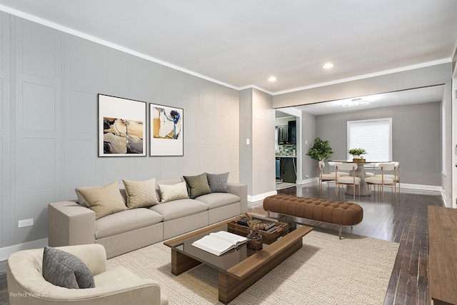 living room with wood-type flooring and crown molding