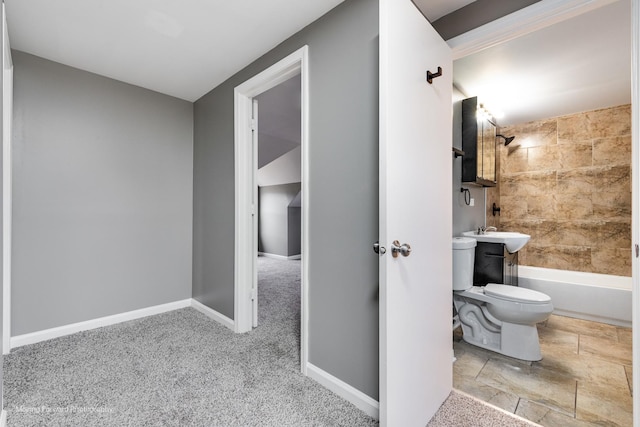 full bathroom featuring tiled shower / bath combo, sink, and toilet