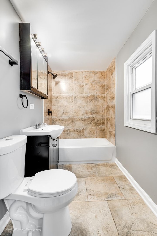 full bathroom featuring vanity, toilet, and tiled shower / bath