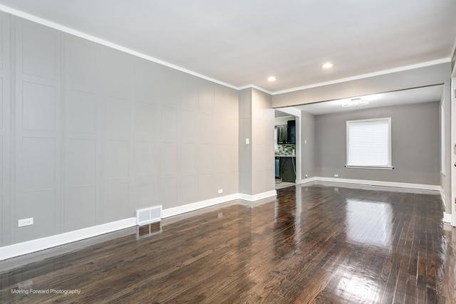 unfurnished living room with crown molding and hardwood / wood-style floors