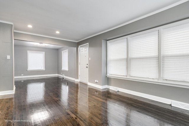 spare room with crown molding and dark hardwood / wood-style floors