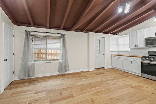 kitchen featuring white cabinetry, decorative light fixtures, stainless steel appliances, and light wood-type flooring