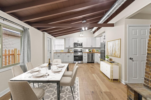 dining space with vaulted ceiling with beams, light wood finished floors, baseboards, and wooden ceiling