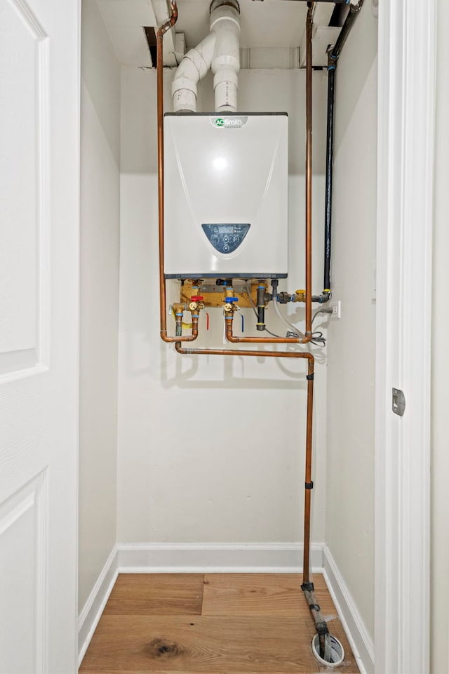 utility room featuring water heater