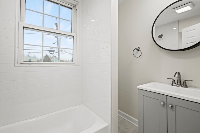 full bathroom with shower / bath combination, baseboards, and vanity