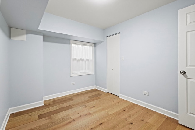 unfurnished room featuring light wood finished floors and baseboards