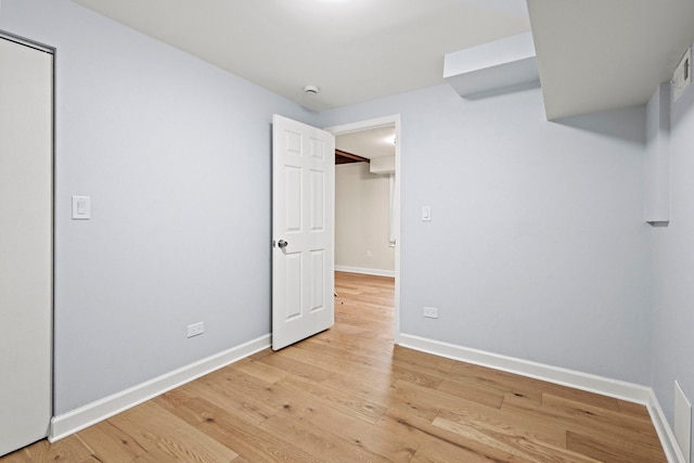 unfurnished bedroom featuring light wood-style flooring and baseboards