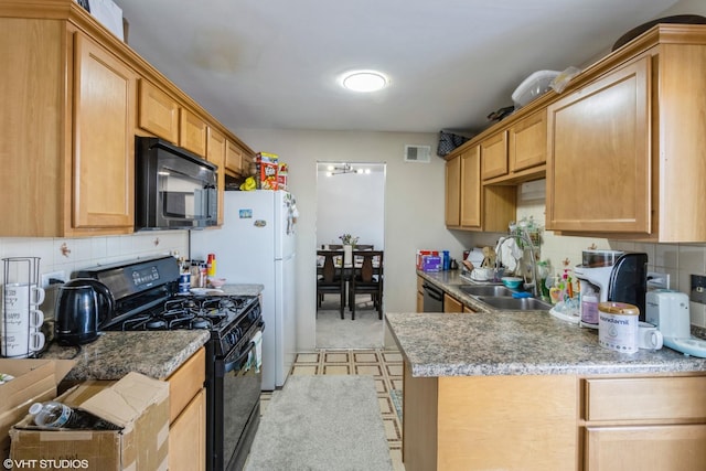 kitchen with sink, decorative backsplash, and black appliances