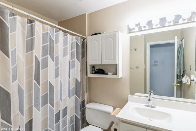 bathroom featuring vanity, a shower with shower curtain, and toilet