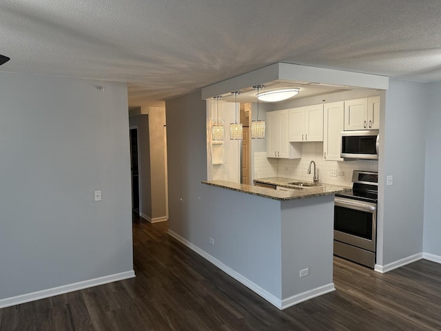 kitchen featuring sink, white cabinetry, stainless steel appliances, light stone counters, and kitchen peninsula