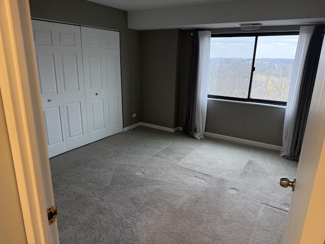 unfurnished bedroom featuring carpet and a closet