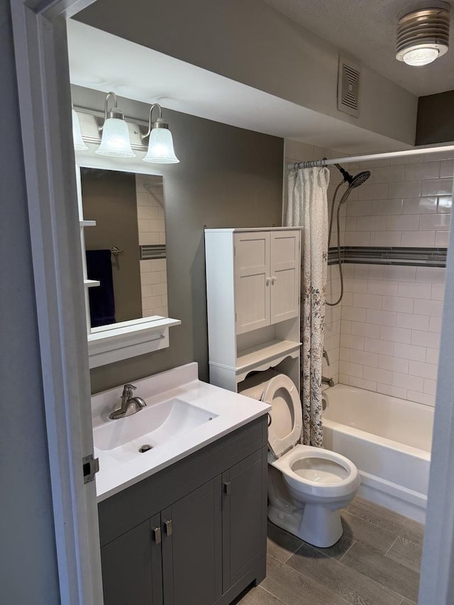 full bathroom with shower / bath combination with curtain, vanity, and toilet