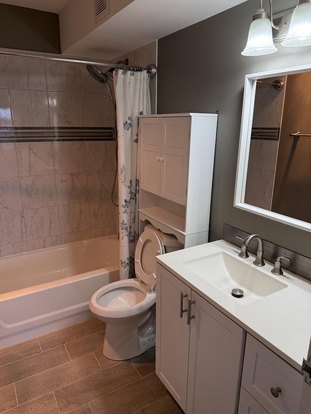 full bathroom with vanity, shower / bathtub combination with curtain, and toilet