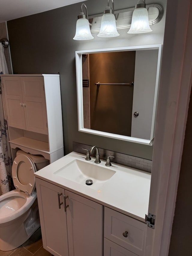 bathroom featuring vanity and toilet