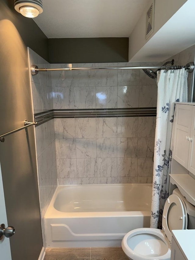 full bathroom with vanity, shower / bath combo, and toilet