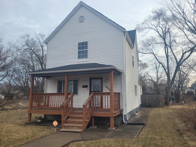 view of front of house featuring covered porch and a front lawn