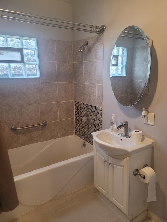 bathroom with vanity, tile patterned floors, and tiled shower / bath