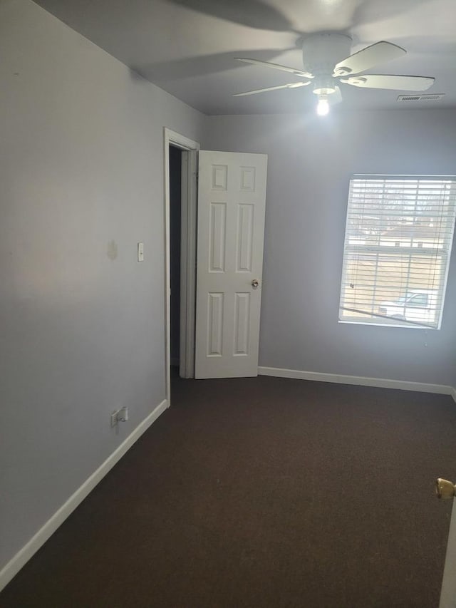 carpeted empty room with ceiling fan