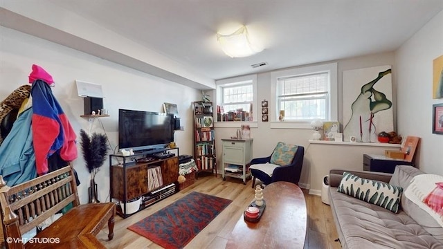 living room featuring light wood finished floors and visible vents