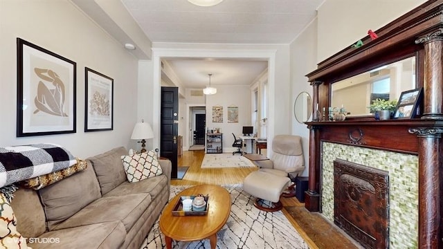 living area featuring light wood-type flooring and a fireplace with flush hearth