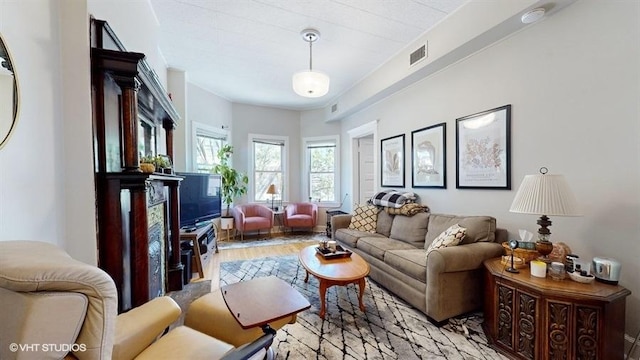 living room with visible vents and light wood-style floors