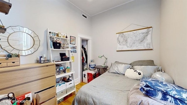 bedroom with visible vents and wood finished floors