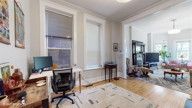 office with baseboards and light wood finished floors