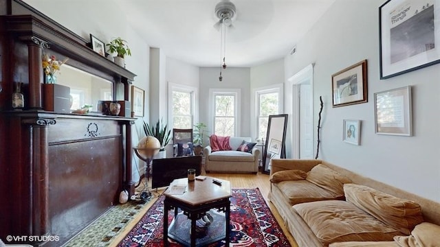 living area with wood finished floors and visible vents