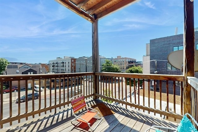 wooden deck featuring a view of city