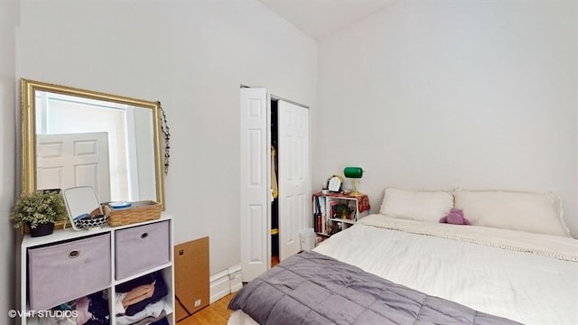 bedroom with vaulted ceiling and light wood-style flooring