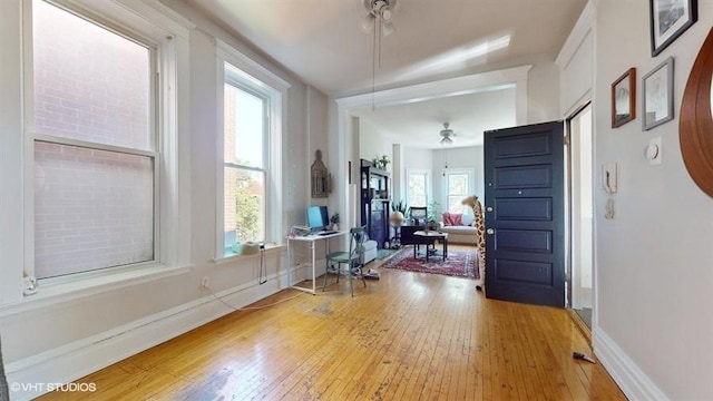 entryway with baseboards and light wood finished floors