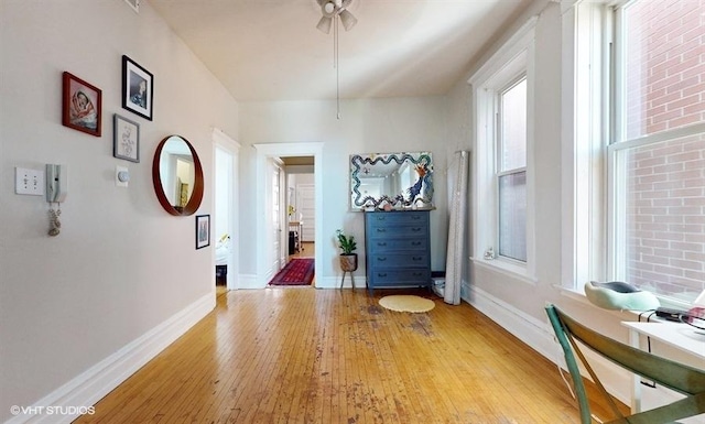 corridor with light wood finished floors and baseboards