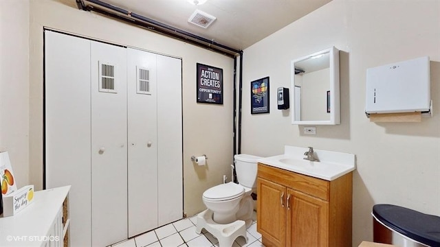 bathroom with toilet, tile patterned floors, visible vents, and vanity