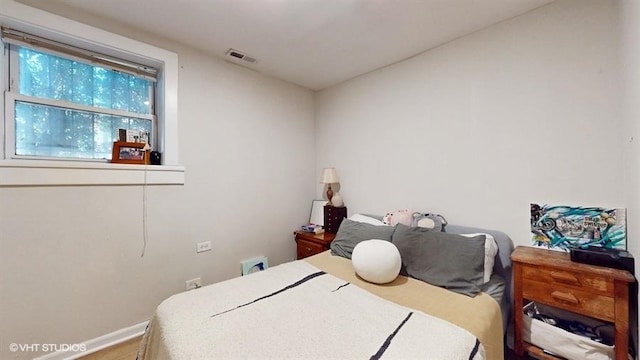 bedroom featuring visible vents and baseboards