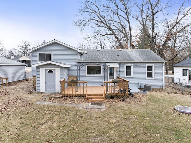 back of house featuring central AC unit, a yard, and a deck