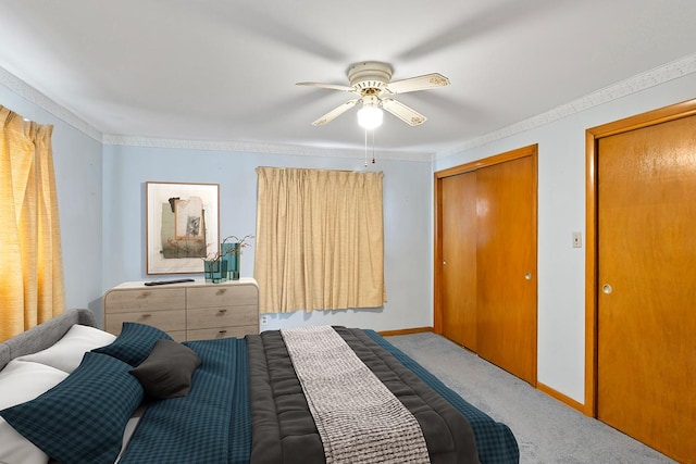 bedroom featuring ornamental molding, a closet, ceiling fan, and carpet flooring