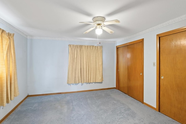 unfurnished bedroom featuring ceiling fan, light colored carpet, and a closet