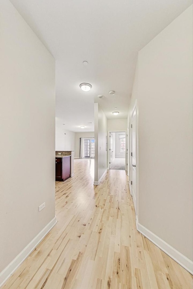 hall with light hardwood / wood-style floors