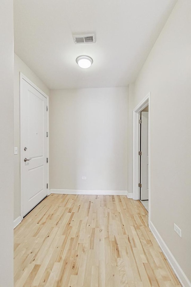 unfurnished room with light wood-type flooring