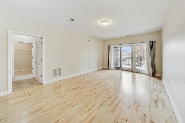 unfurnished room with light hardwood / wood-style floors