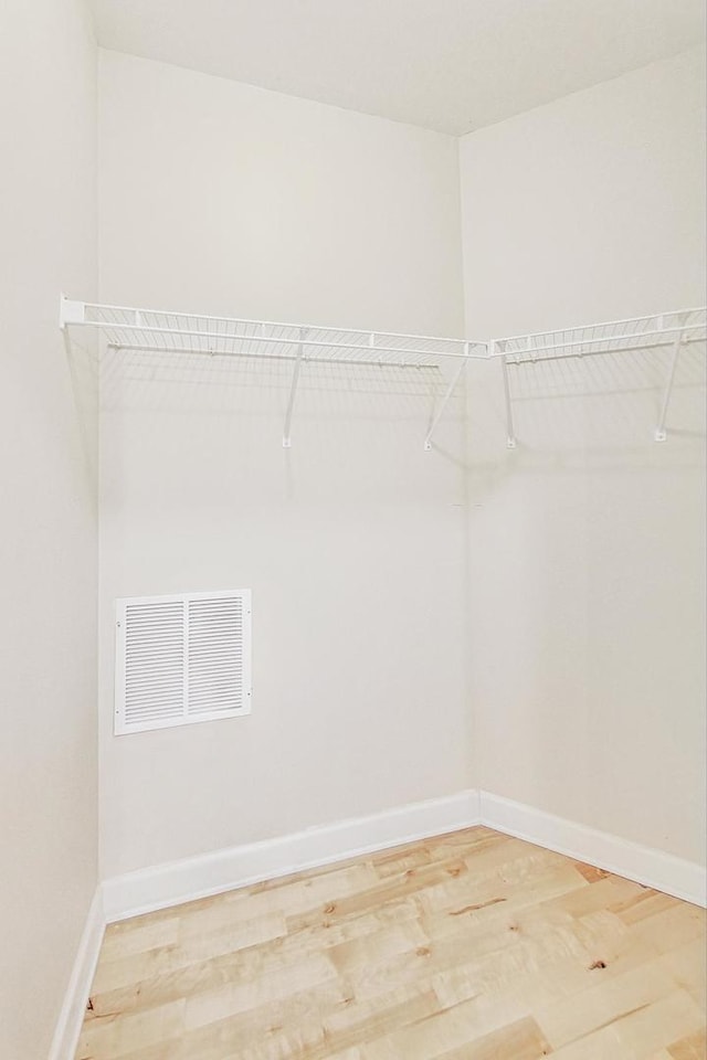 spacious closet featuring hardwood / wood-style flooring