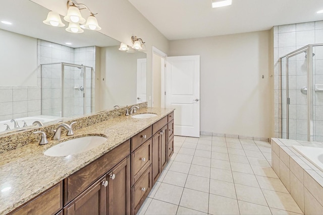 bathroom featuring tile patterned flooring, vanity, and separate shower and tub