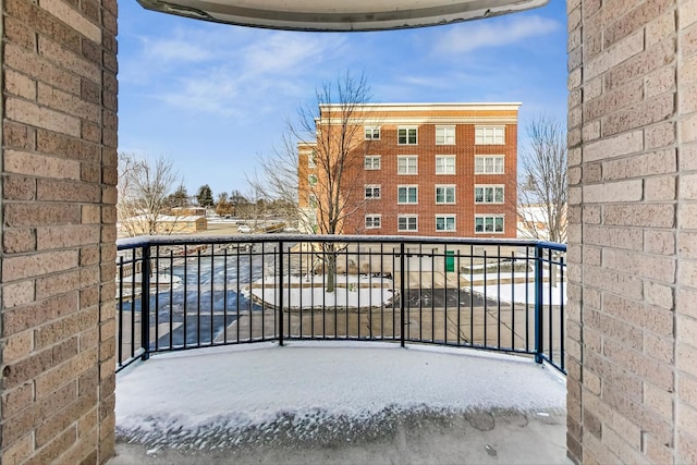 view of snow covered back of property