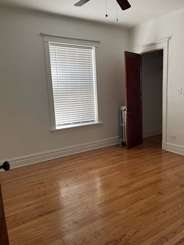 empty room featuring hardwood / wood-style flooring and ceiling fan