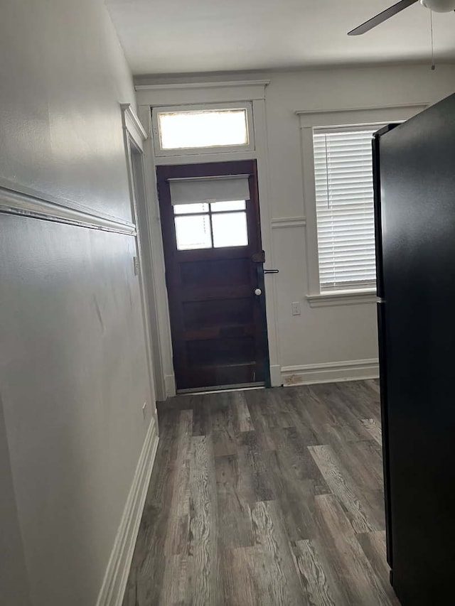 entryway with dark hardwood / wood-style flooring and ceiling fan