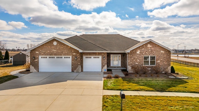 single story home with a garage and a front lawn