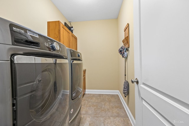 laundry room with cabinets and washer and dryer