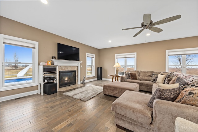 living room featuring dark hardwood / wood-style flooring and ceiling fan